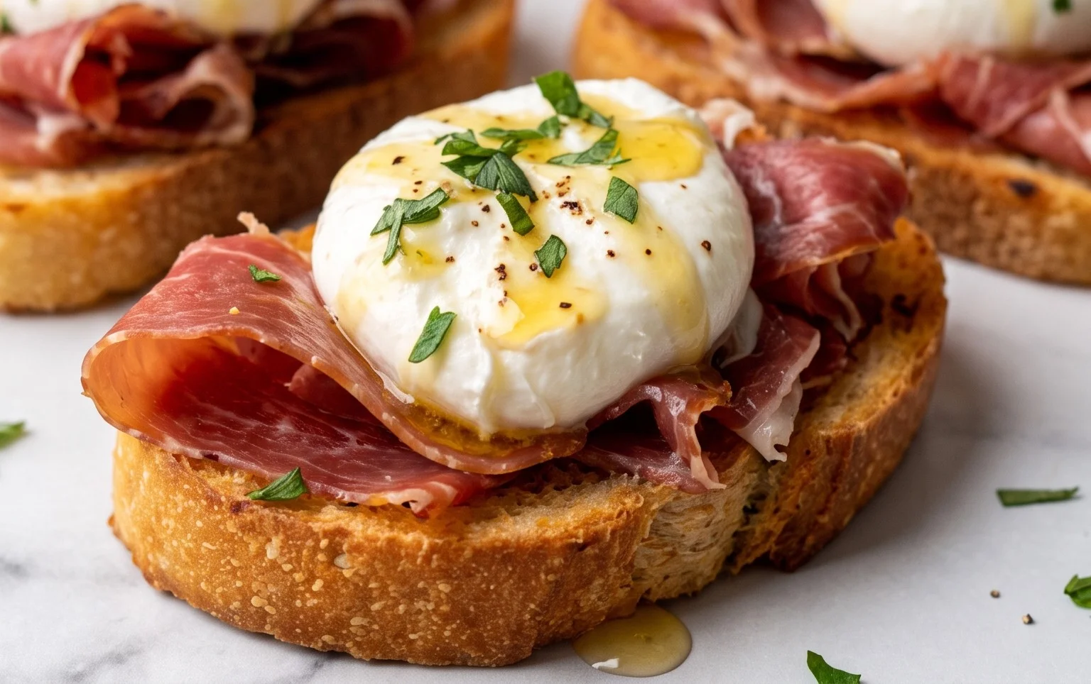 Beef Prosciutto Crostini with Burrata and Lemon Honey Drizzle